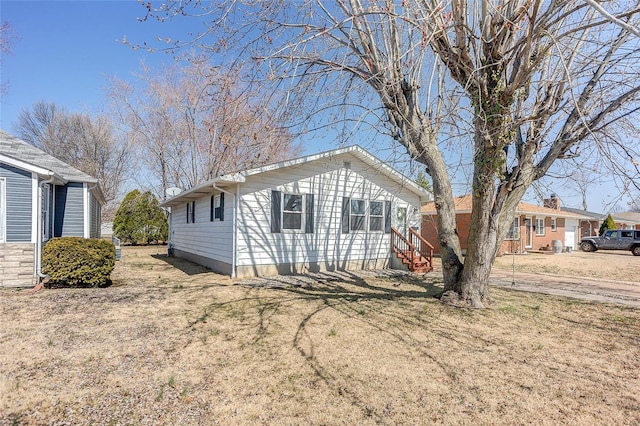 exterior space with a front lawn and entry steps