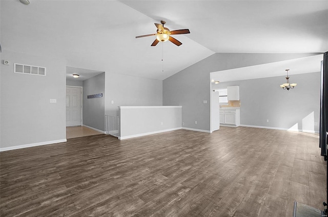 unfurnished living room featuring visible vents, baseboards, dark wood finished floors, vaulted ceiling, and ceiling fan with notable chandelier