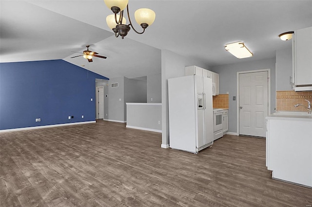 kitchen featuring white appliances, dark wood-style flooring, light countertops, and ceiling fan with notable chandelier