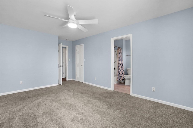 unfurnished bedroom with carpet flooring, connected bathroom, baseboards, and ceiling fan