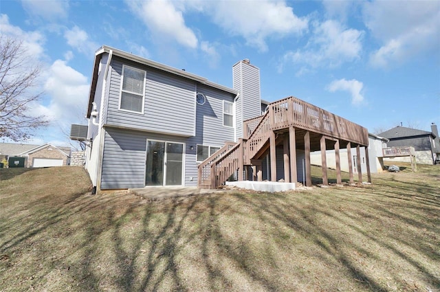 back of house with a deck, stairway, a yard, a chimney, and a patio area