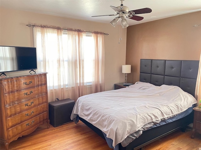 bedroom featuring light wood-style floors and ceiling fan