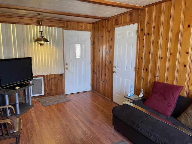 foyer with wooden walls and wood finished floors