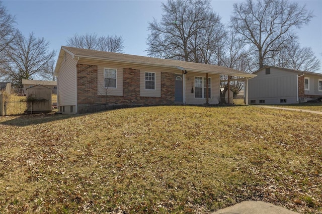 ranch-style house featuring a front yard and brick siding