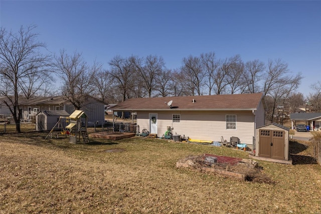 back of property featuring an outbuilding, a playground, a yard, and a shed