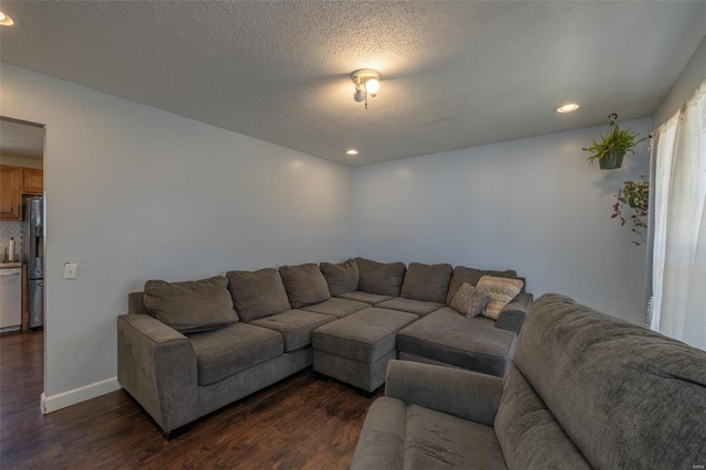 living area with a textured ceiling, dark wood-style flooring, baseboards, and recessed lighting