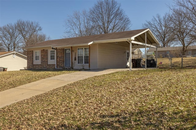 view of front of property featuring a front yard, brick siding, fence, and an attached carport