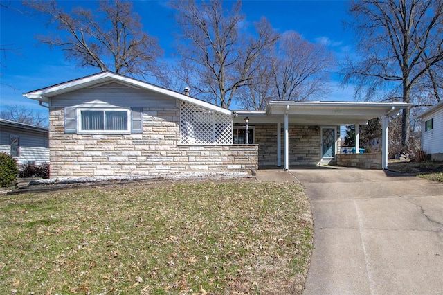 single story home featuring stone siding, a carport, driveway, and a front lawn