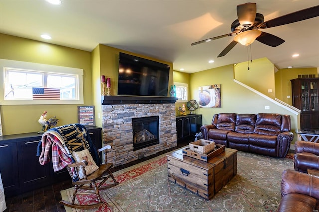 living area with wood finished floors, recessed lighting, a fireplace, and ceiling fan