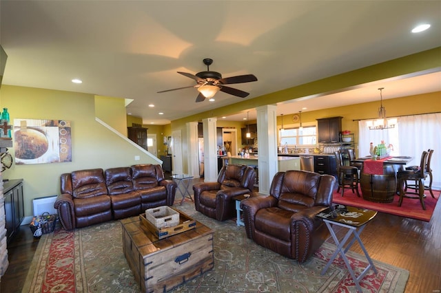 living area featuring recessed lighting, ceiling fan with notable chandelier, ornate columns, and wood finished floors