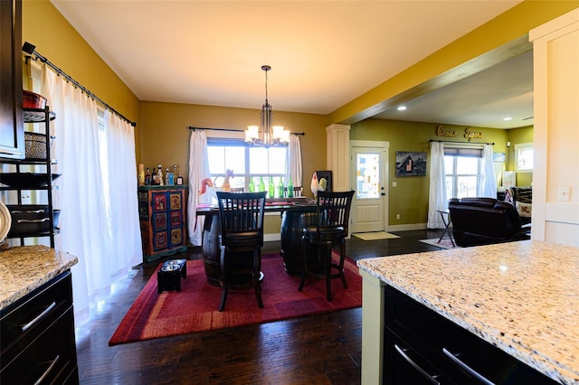 dining space with recessed lighting, baseboards, an inviting chandelier, and dark wood-style flooring