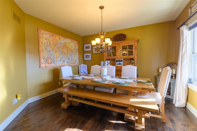 dining area with a notable chandelier, wood finished floors, visible vents, and baseboards