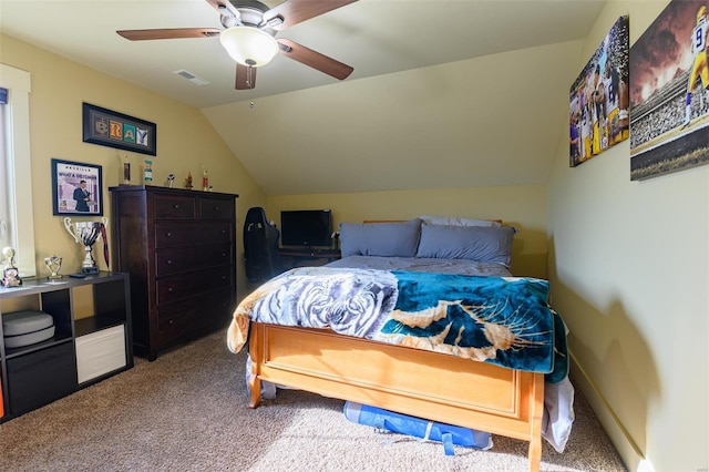 bedroom with visible vents, baseboards, carpet floors, vaulted ceiling, and a ceiling fan