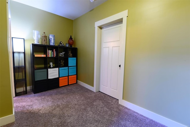 carpeted bedroom featuring baseboards