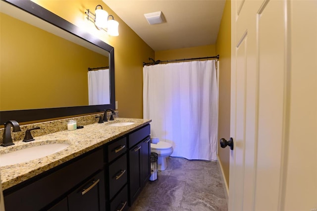 bathroom with a sink, toilet, a shower with shower curtain, and double vanity