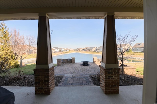 view of patio / terrace featuring a water view and a residential view