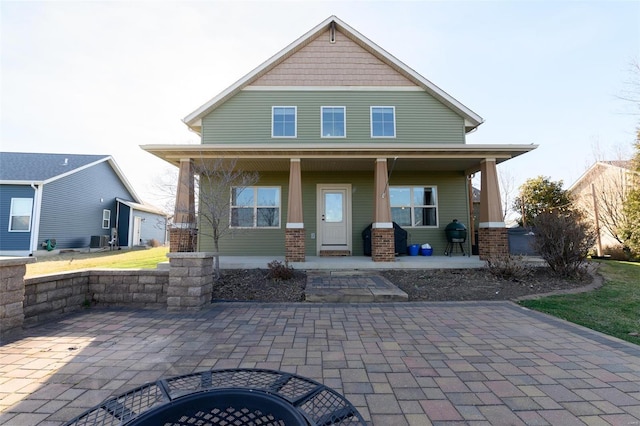 back of house featuring cooling unit and a porch