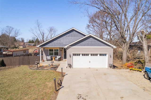 view of front of property with a garage, driveway, a front lawn, and fence