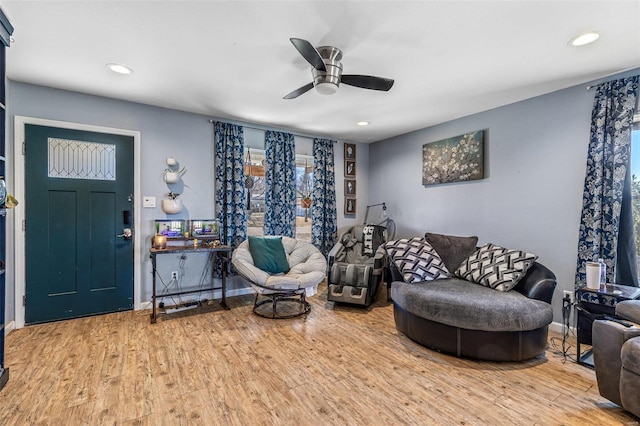 living area with wood finished floors, a ceiling fan, and recessed lighting