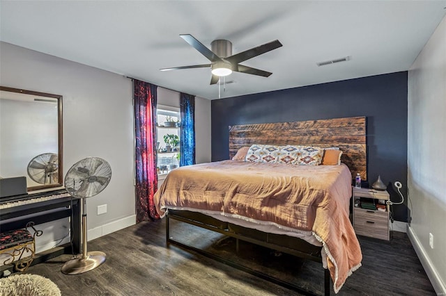 bedroom with baseboards, visible vents, ceiling fan, and wood finished floors