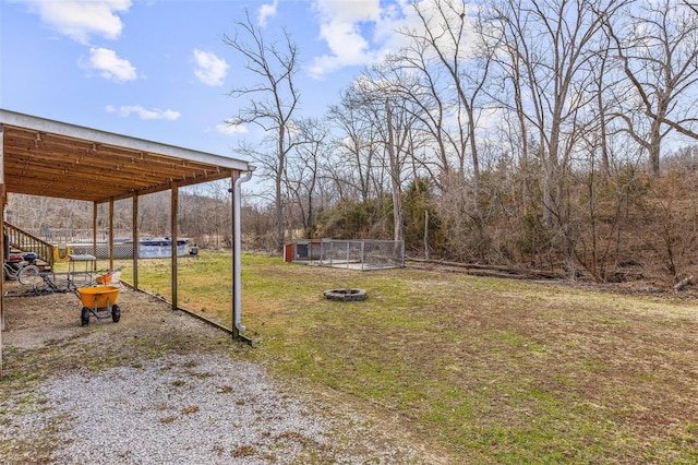 view of yard featuring a carport and driveway