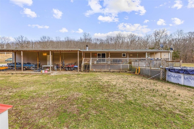 rear view of property with a covered pool and a lawn