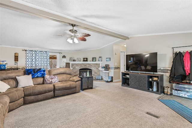 carpeted living area with a fireplace, visible vents, lofted ceiling with beams, ornamental molding, and a textured ceiling