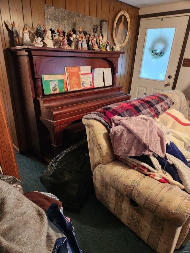 bedroom featuring carpet flooring and wooden walls