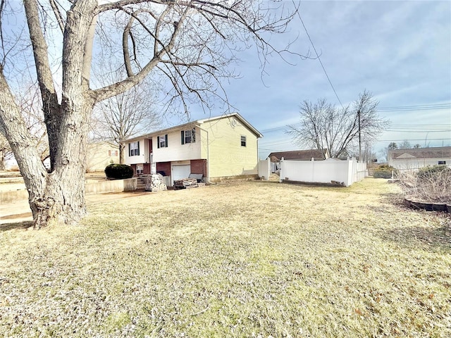 exterior space with driveway, a garage, fence, and brick siding