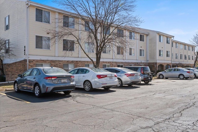 view of building exterior featuring uncovered parking