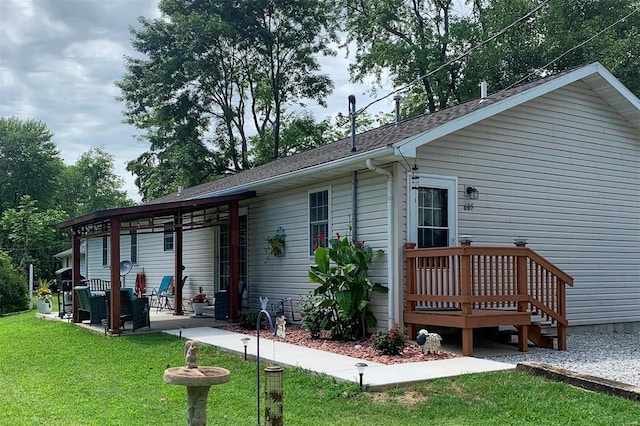 rear view of house with a patio area and a lawn