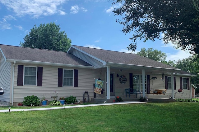 single story home with a porch, a front yard, and a shingled roof