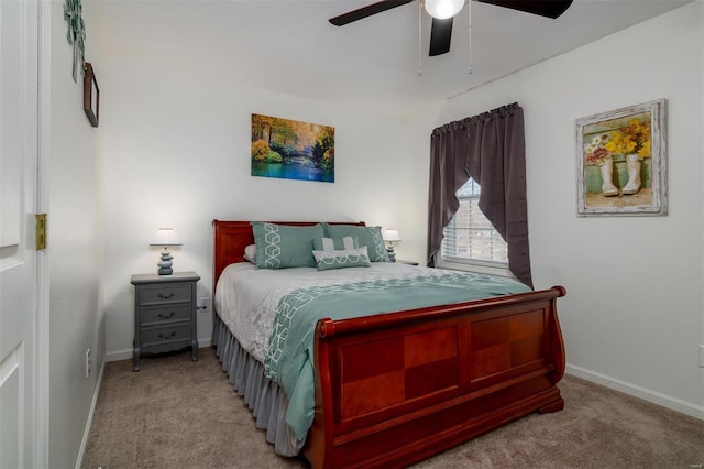 carpeted bedroom with a ceiling fan and baseboards