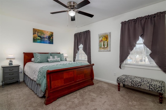 carpeted bedroom with multiple windows, baseboards, and ceiling fan