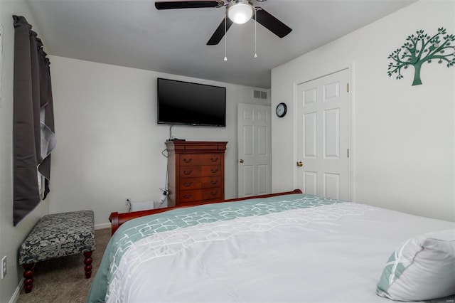 carpeted bedroom featuring visible vents, baseboards, and a ceiling fan