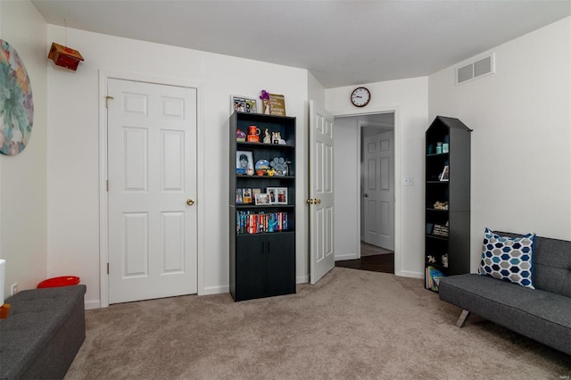 sitting room with visible vents, baseboards, and carpet