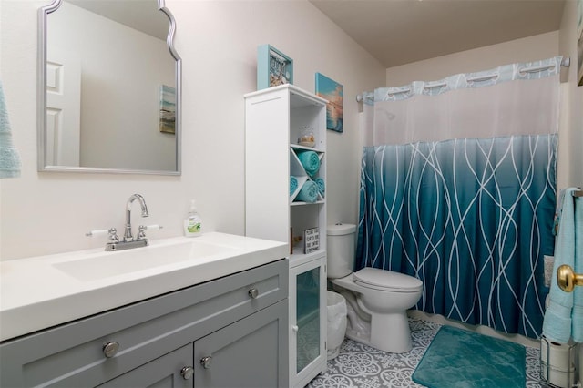 bathroom with vanity, toilet, a shower with curtain, and tile patterned flooring