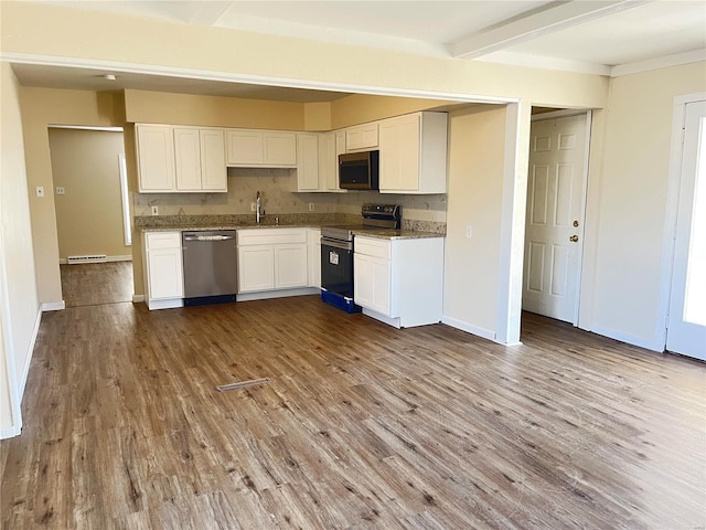 kitchen featuring appliances with stainless steel finishes, white cabinetry, and wood finished floors