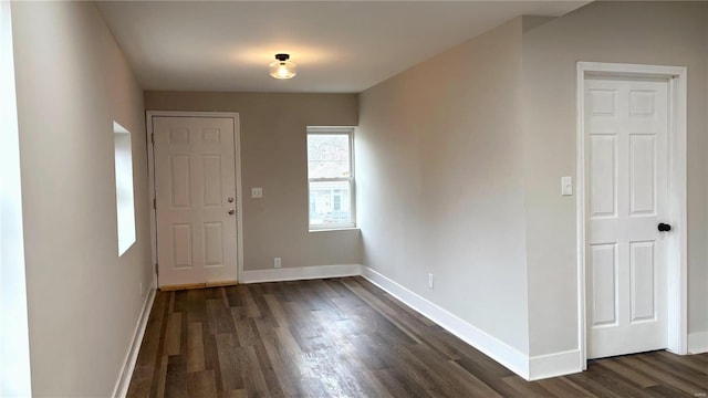 entrance foyer featuring dark wood-type flooring and baseboards