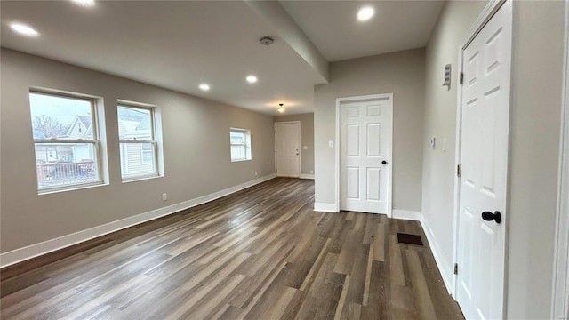 unfurnished bedroom featuring visible vents, recessed lighting, baseboards, and dark wood-style flooring