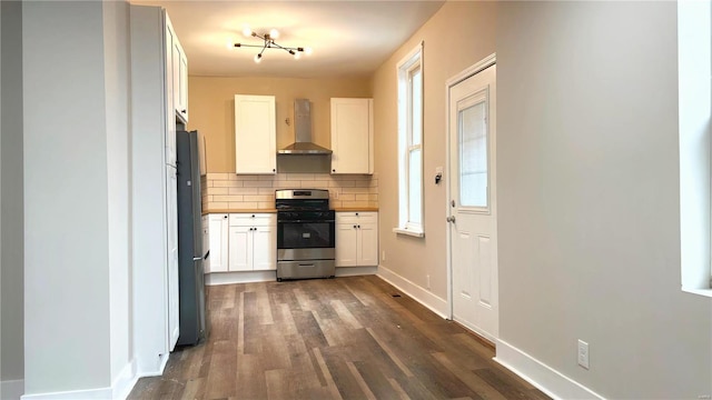 kitchen featuring backsplash, stainless steel appliances, dark wood-style floors, white cabinetry, and wall chimney exhaust hood