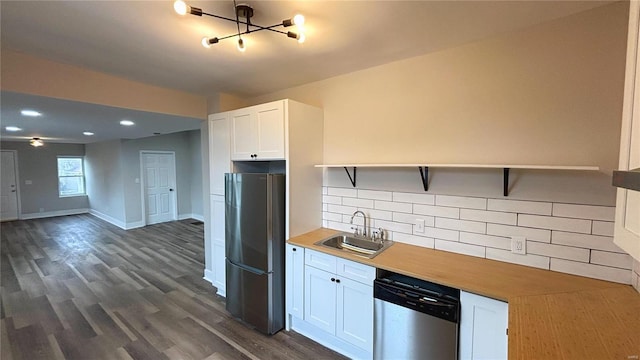 kitchen featuring a sink, stainless steel appliances, open shelves, and decorative backsplash