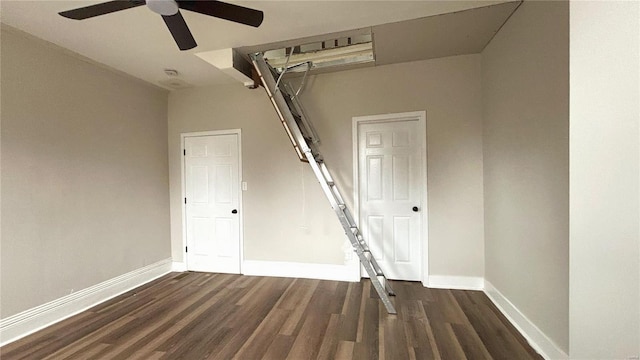 interior space featuring a ceiling fan, baseboards, and wood finished floors