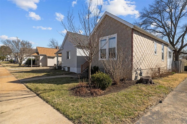 view of property exterior featuring a lawn