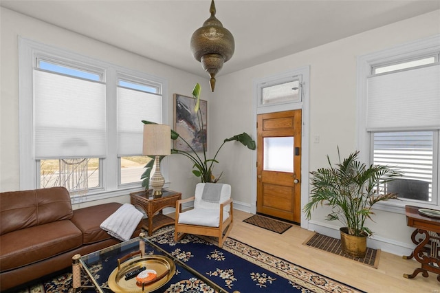 living room featuring plenty of natural light, baseboards, and wood finished floors