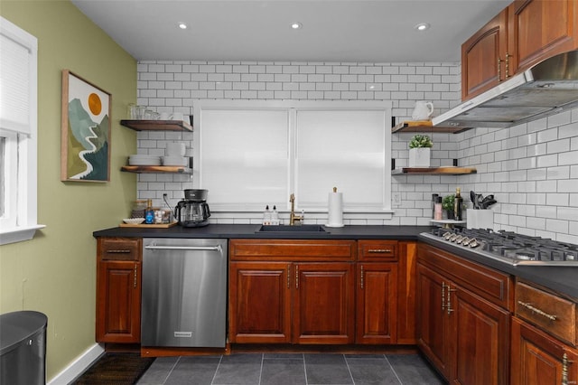 kitchen with open shelves, appliances with stainless steel finishes, dark countertops, and a sink