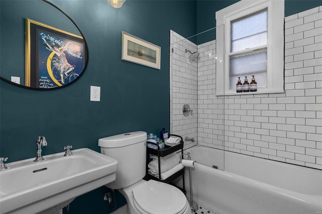 bathroom with toilet, a sink, and shower / bathing tub combination