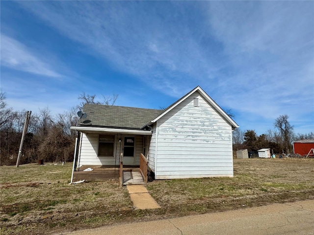 view of front of property with a porch and roof with shingles