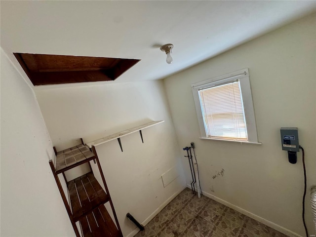 laundry area featuring baseboards