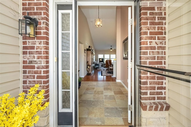 doorway to property featuring brick siding